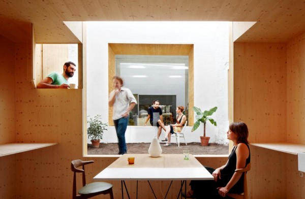 Glass windows provide portals between exhibition, courtyard and studio spaces. Image by José Hevia via MAIO.