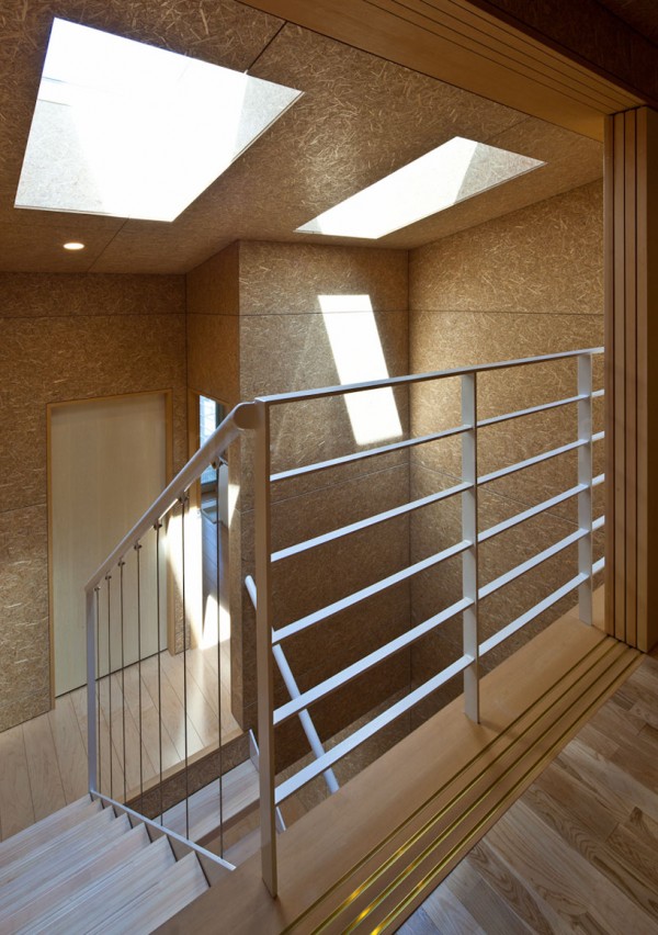 Skylights draw natural light into the stairwell, lined with exposed OSB and hardwood floors. Image by Stirling Elmendorf via Shuhei Endo.