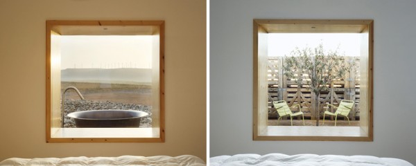 Window views of wind turbines and recycled wooden palette wind breaks. Image via Hotel Aire de Bardenas.