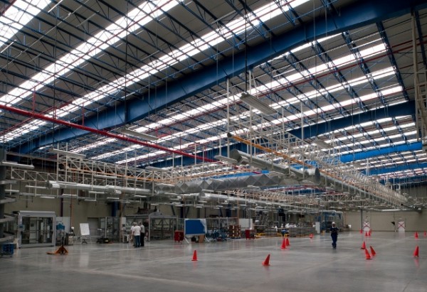 The high ceiling inside the Jiutepec plant includes skylights to bring natural daylight into the interior. Image via Unilever.