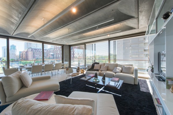 Each apartment includes full-length windows and vaulted concrete ceilings to aid in ventilation. Image by Nigel Young via Faena Group.