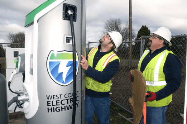 Workers put the finishing touches on installing a plug-in electric vehicle charger that is part of the West Coast Electric Highway. (image via Columbia-Willamette Clean Cities Coalition)