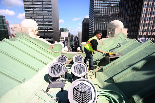A worker installs some of the multicolored Lumenplus LED lamps on the roof of the Helmsley Building. Image by Ed Lederman via Monday Properties.