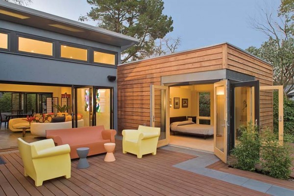 An example of the folding-door feature to bring in tropical breezes. Image via Blu Homes.