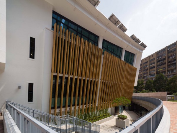 A view of ZCB's northwest-facing windows, with wooden louvers to control afternoon solar gain. Image via Ronald Lu & Partners.