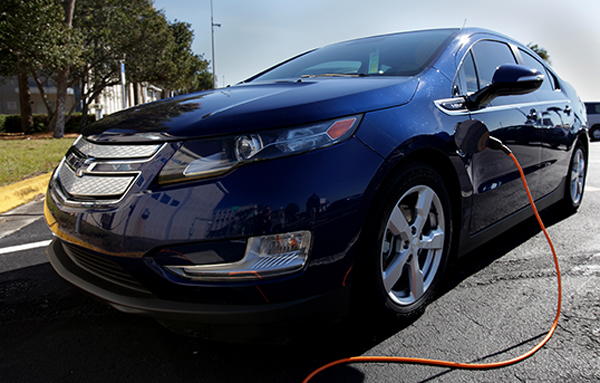 An electric car taking part in a program to investigate potential ways to lower emissions is seen plugged in at Kennedy. Image Credit: NASA